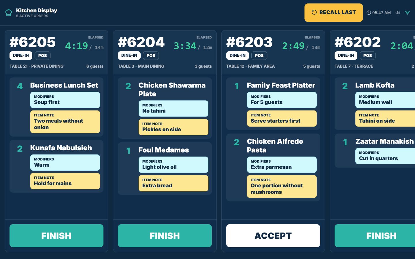 TajerGo kitchen display with dine-in tickets labelled by table and area, guest counts, modifiers and item notes