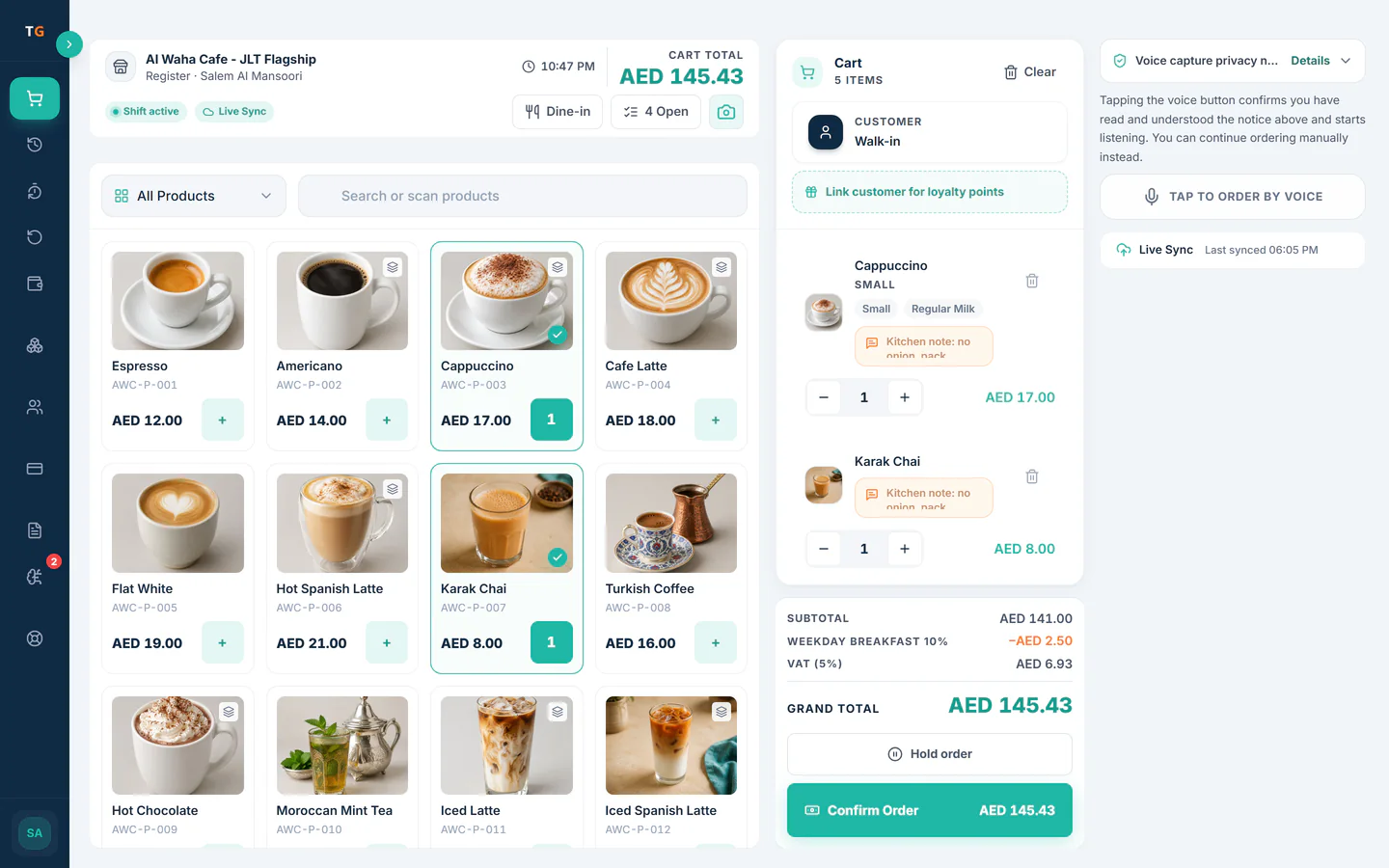 TajerGo POS till at Al Waha Cafe with the Tap to order by voice button, five items in the cart, item photos in the product grid, VAT 5% and the AED 145.43 grand total above the Confirm Order button, demonstration data
